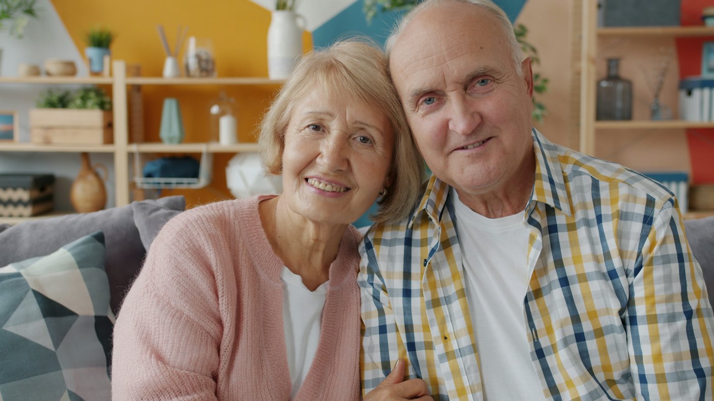 A smiling older couple at home