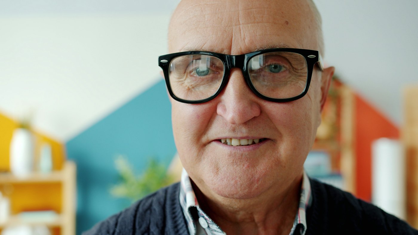 A smiling older man at home